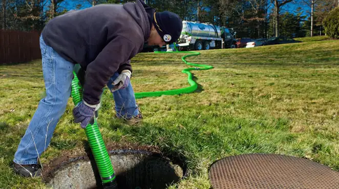 Service technician performing residential septic pumping and drainage maintenance in Colorado Springs, CO